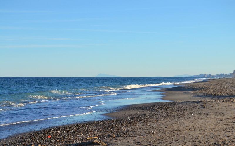 Strand van La Devesa bij Valencia met zicht op de bergen in de verte